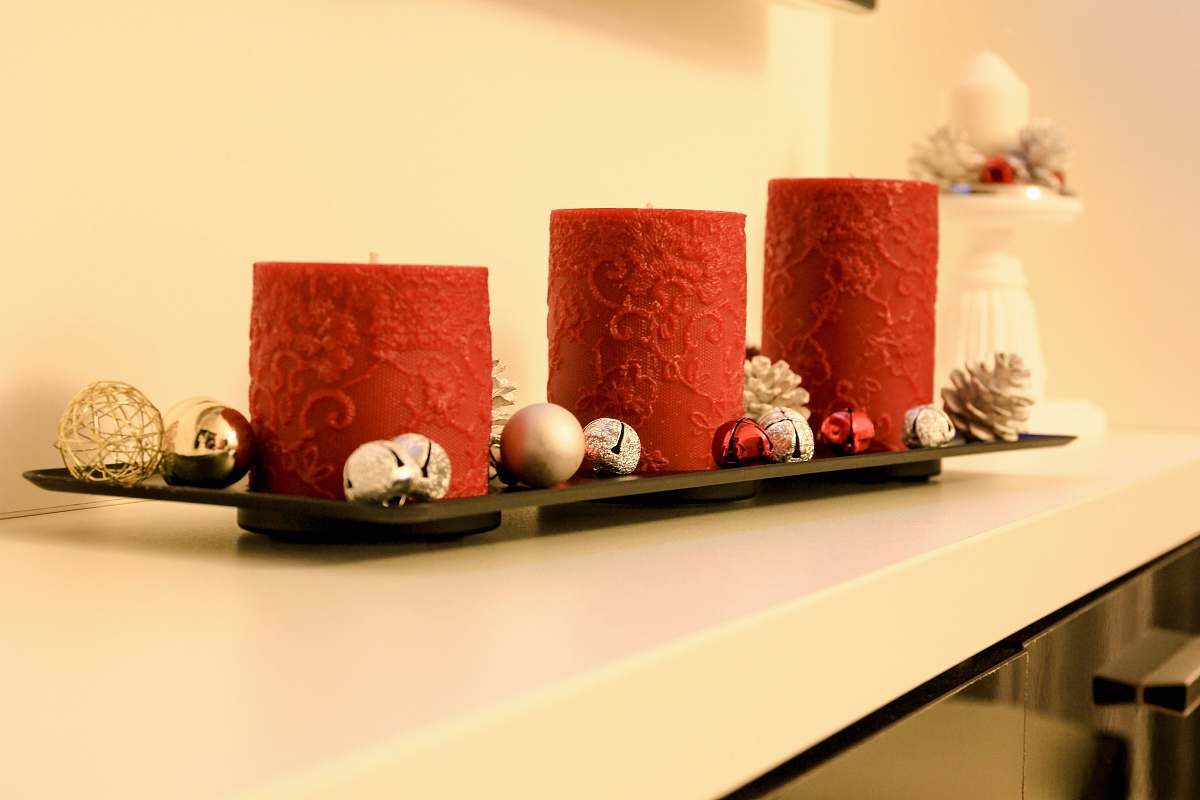 furniture three red pillar candles on black holder table